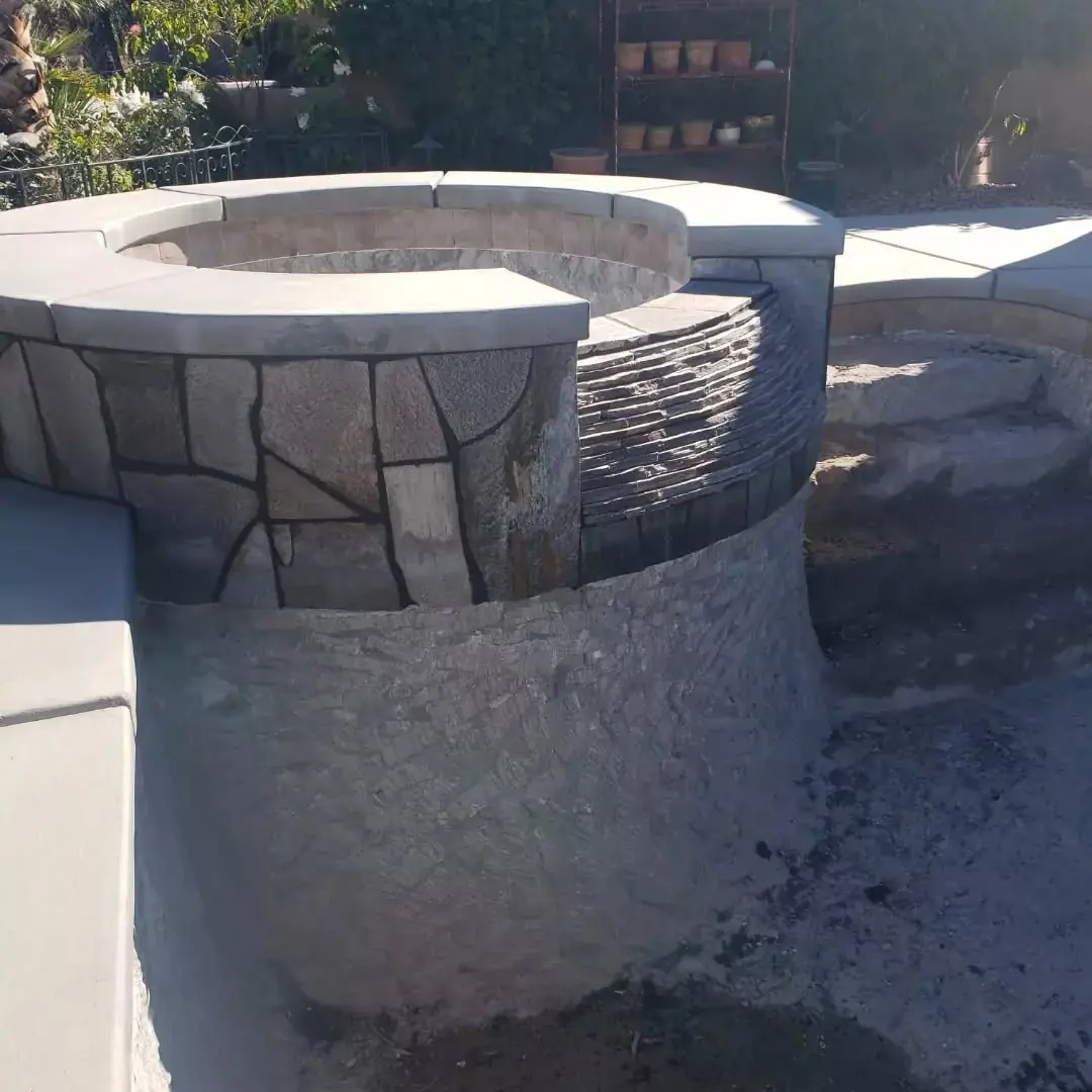 Raised stone spa beside the pool